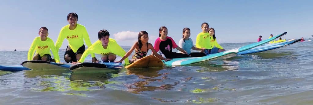 group of kids on surf boards